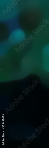unfocused vertical format background with black, teal green and very dark blue colors and space for text or image