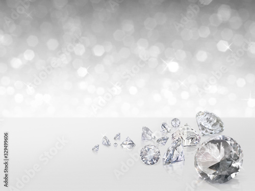 Group of diamonds placed on white background on the right with bokeh