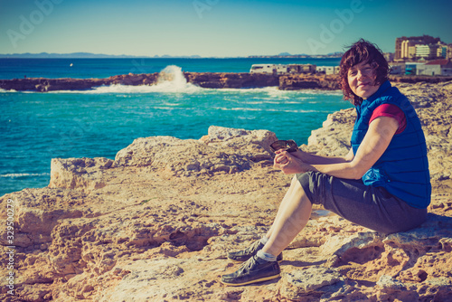 Tourist woman on sea cliffs in Spain