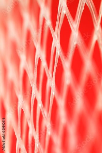 close up of white plastic net on red  background cover