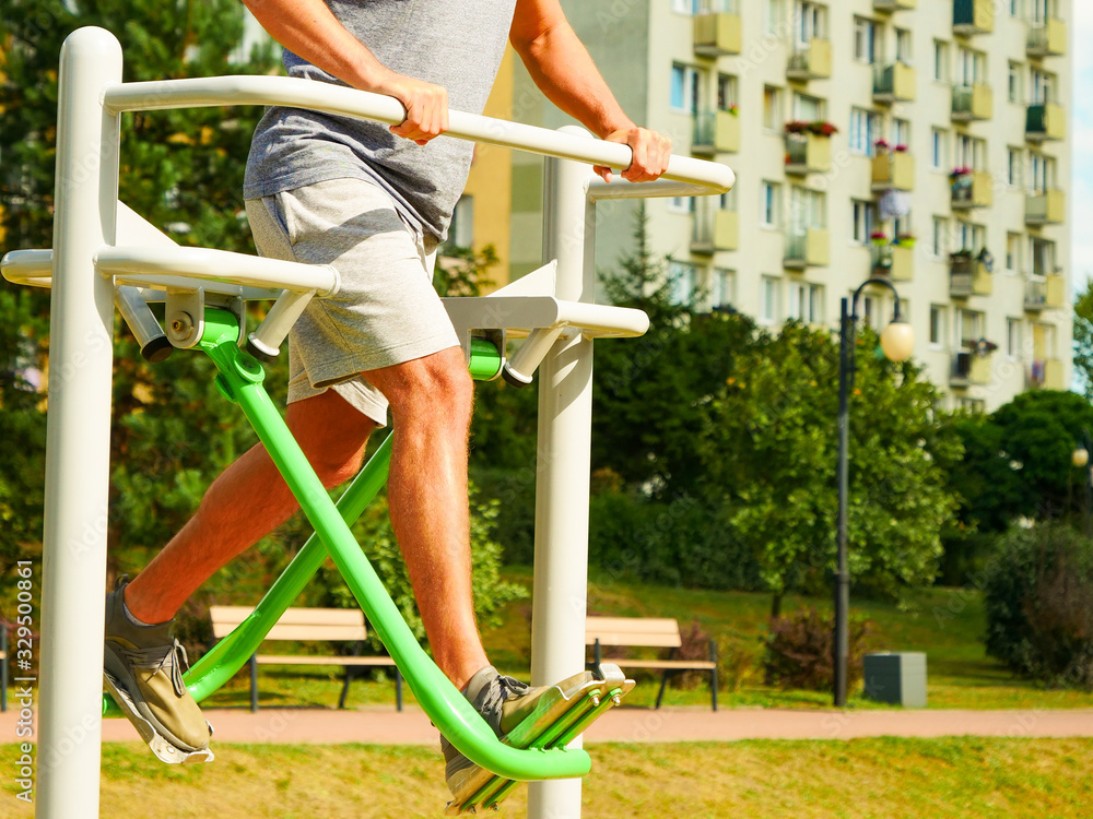 Fototapeta premium Man doing legs exercises in outdoor gym