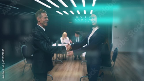 The businessman and businesswoman handshaking in the meeting room. slow motion photo