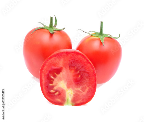 Fresh red tomatoes split on a white background.