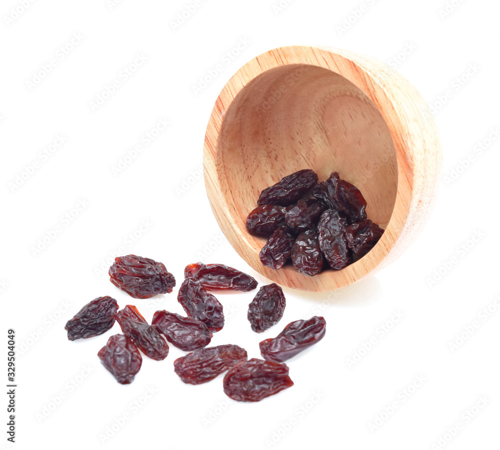 Fototapeta premium Dried raisins in wooden cup on white background.