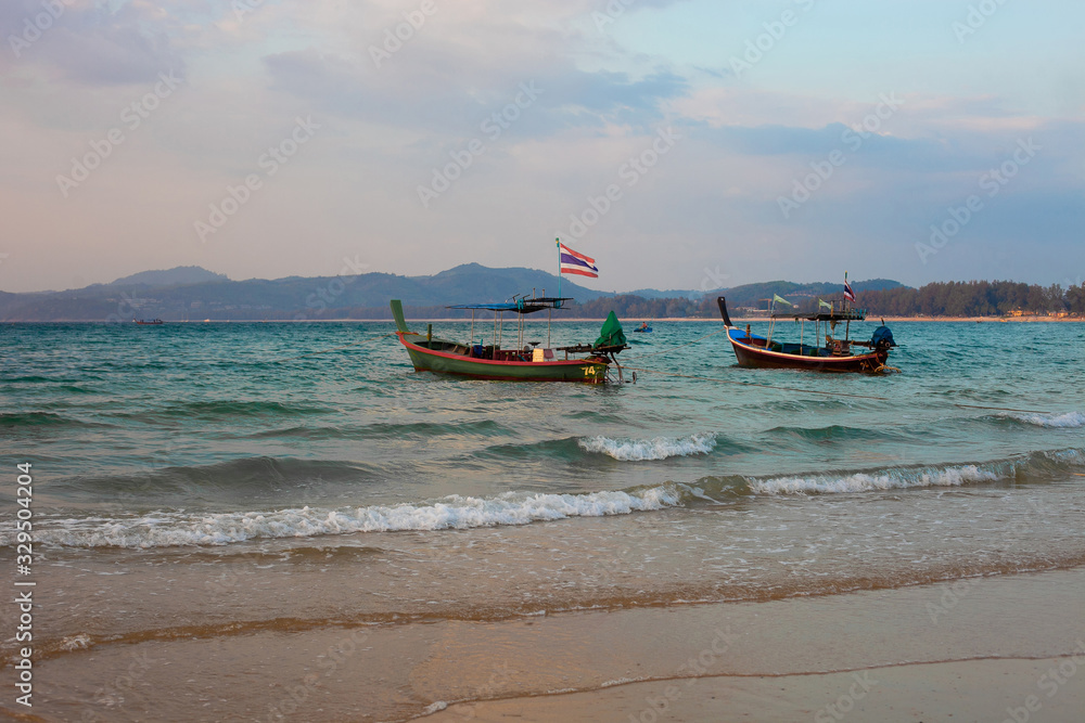 traditional old fisherman boat on the beach near tropical island traditional old fisherman boat on the beach near tropical island