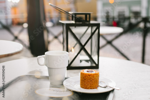 Wallpaper Mural cup of coffee and traditional dessert on wooden table on the street in Europe village Porvoo Finland Torontodigital.ca