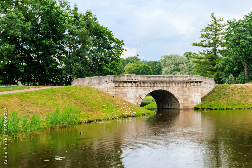 Stone arch bridge across a lake in Gatchina, Russia