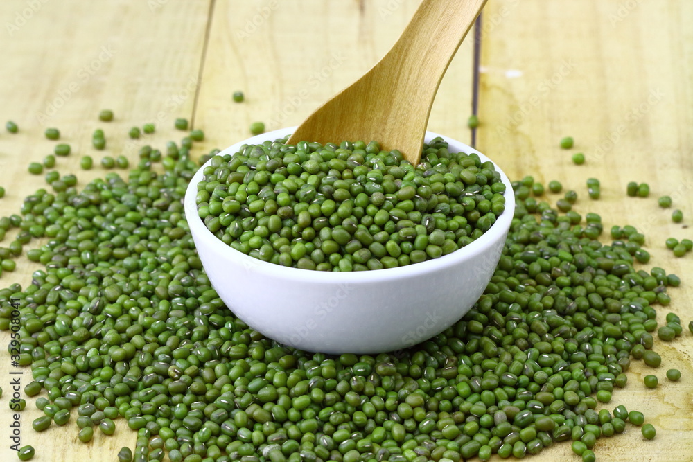mung beans in ceramic bowl and spoon on wooden table top mung beans in ceramic bowl and spoon on wooden table top