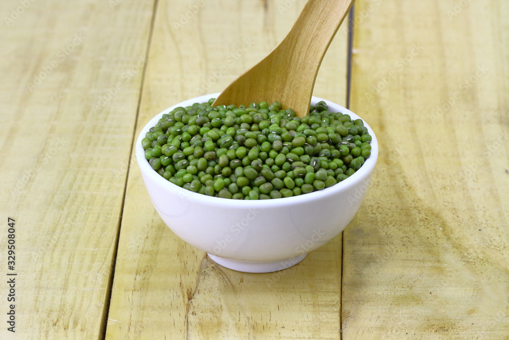 mung beans in ceramic bowl and spoon on wooden table top mung beans in ceramic bowl and spoon on wooden table top