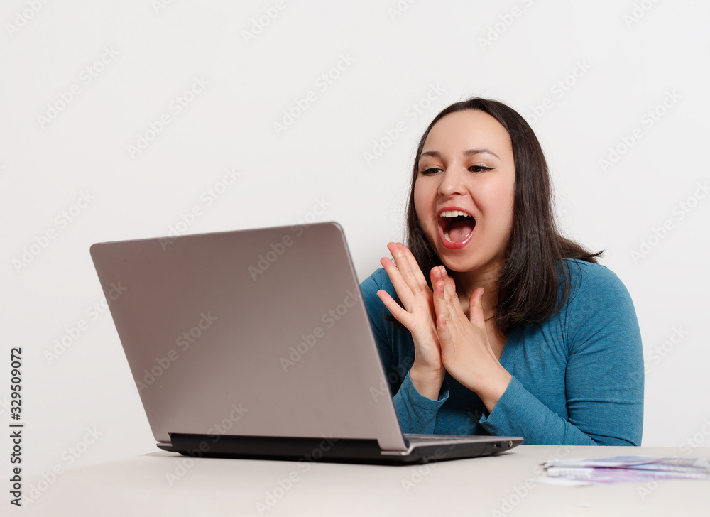 happy happy contented woman sitting at her laptop. the concept of success, freelancing, remote earnings, computer technology, lottery, winning happy happy contented woman sitting at her laptop. the concept of success, freelancing, remote earnings, computer technology, lottery, winning
