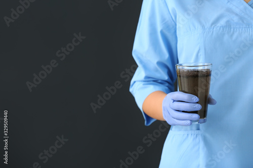 Female doctor with glass of...