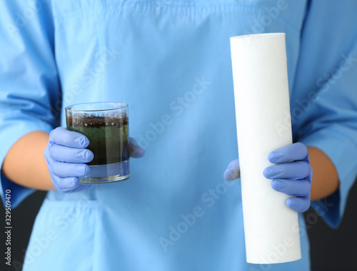Female doctor with glass of...