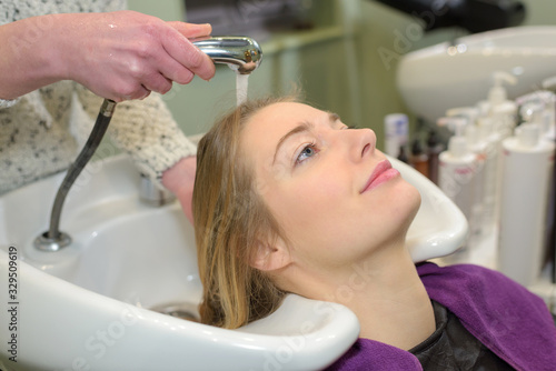 woman relaxing while having hair washed