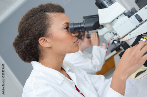 a microscope and female researcher