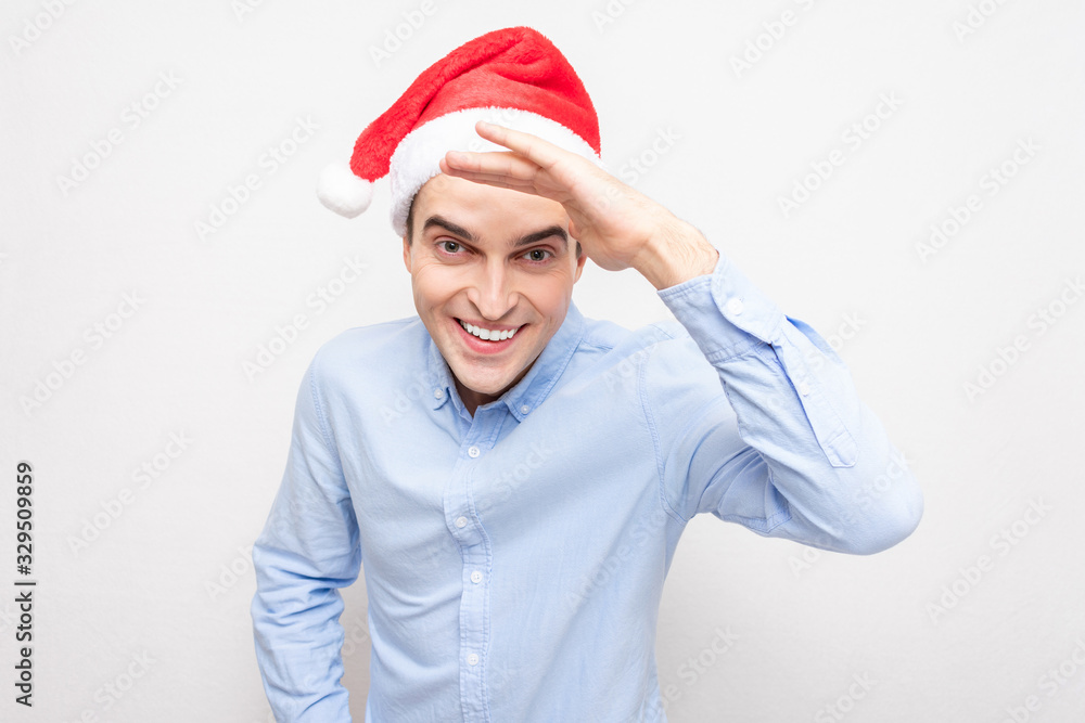 Funny guy in the hat of Santa Claus smiles, man looking at camera, portrait, white background Funny guy in the hat of Santa Claus smiles, man looking at camera, portrait, white background
