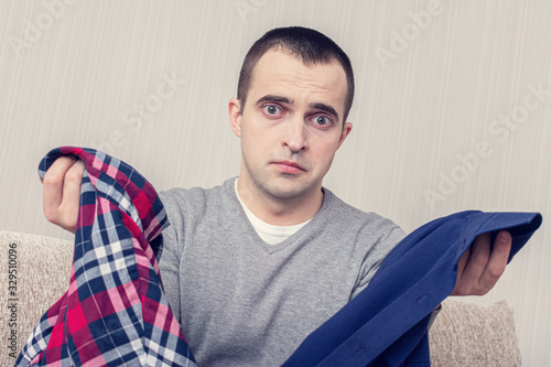 Photos Man with scattered clothes, guy does not know what to wear, portrait, toned