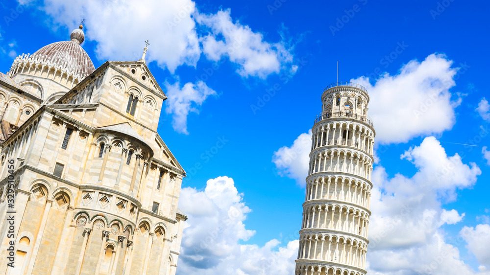 Cloudy day with blue sky at Pisa Cathedral (Duomo di Pisa) with Leaning Tower  (Torre di Pisa) Tuscany, Italy.The Leaning Tower of Pisa is one of the main landmark in Italy.