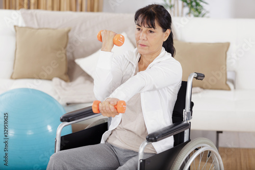 a disabled woman dumpbells exercises photo