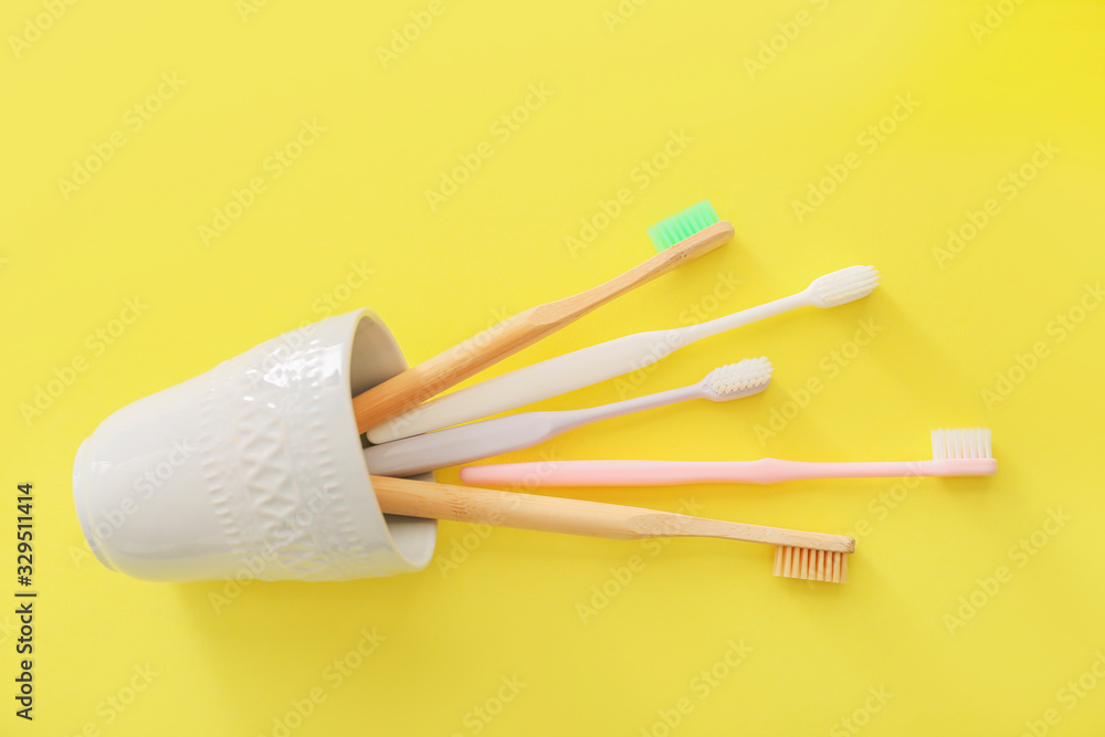 Holder with tooth brushes on color background Holder with tooth brushes on color background