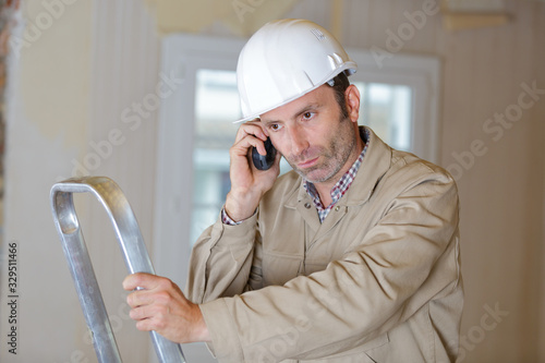 male builder on the phone