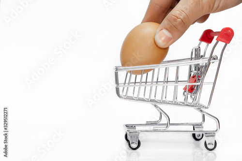 Shopping cart , The hand is picking the chicken in the cart