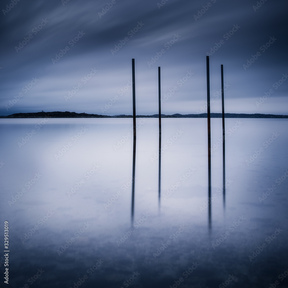 Posts in water at dusk, Gothenburg, Sweden Posts in water at dusk, Gothenburg, Sweden