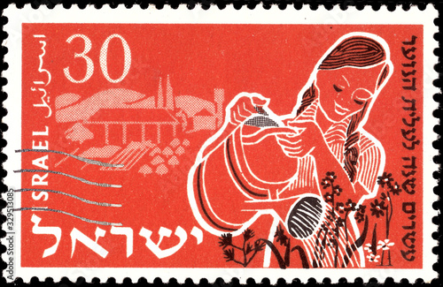  A stamp printed in Israel, shows young woman watering flowers , issued in honor of 20th anniversary of Youth Immigrants - Aliyah