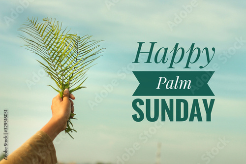 Happy Palm Sunday concept with text design. On background of  young woman holding fern or palm leaf in hand against bright blue sky. photo