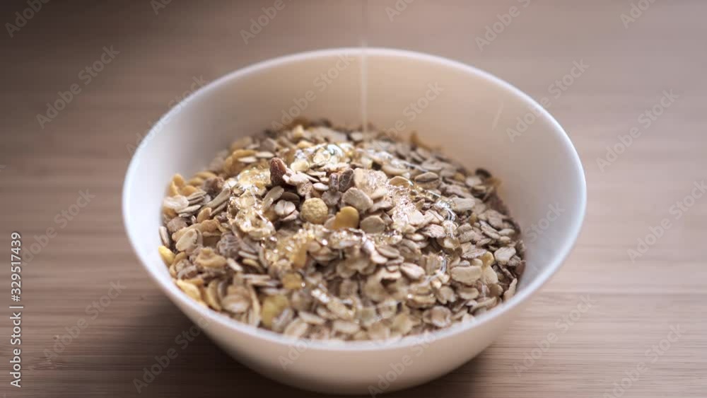 Honey being poured on top of cereal, 4K. Honey being poured on top of cereal, 4K.