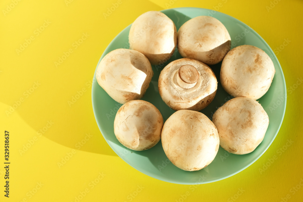 Fototapeta premium Mushrooms champignons on a yellow background