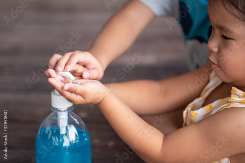 Child Hands Using Wash Hand Sanitizer Gel Pump Dispenser, Selected Focus