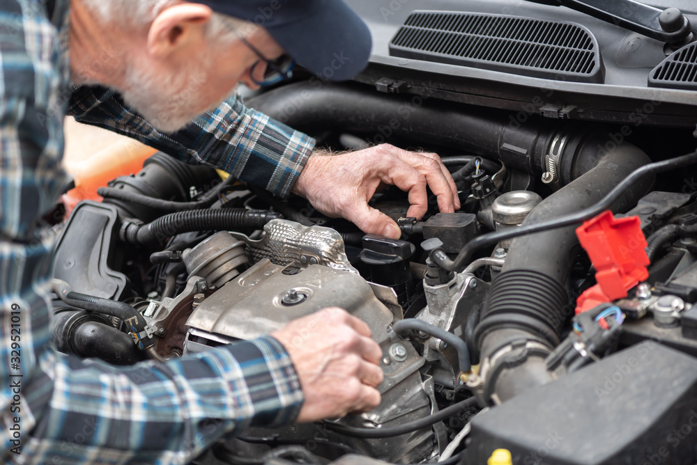 Car mechanic working on car engine Car mechanic working on car engine