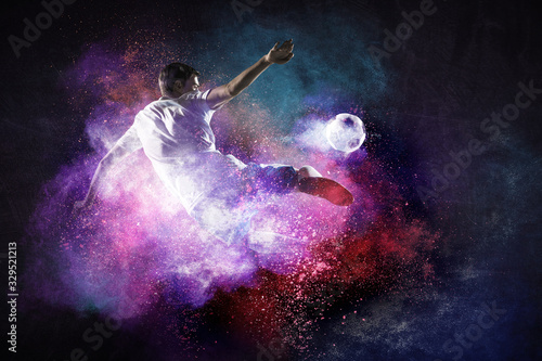 Boy playing soccer hitting the ball © Sergey Nivens
