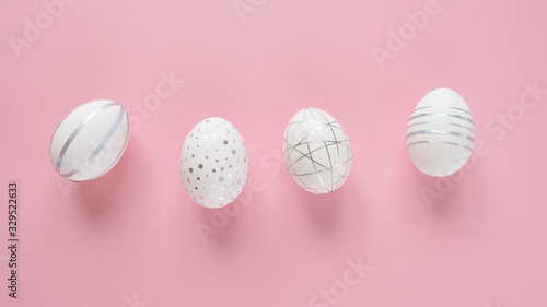 White easter eggs with silver pattern on pink