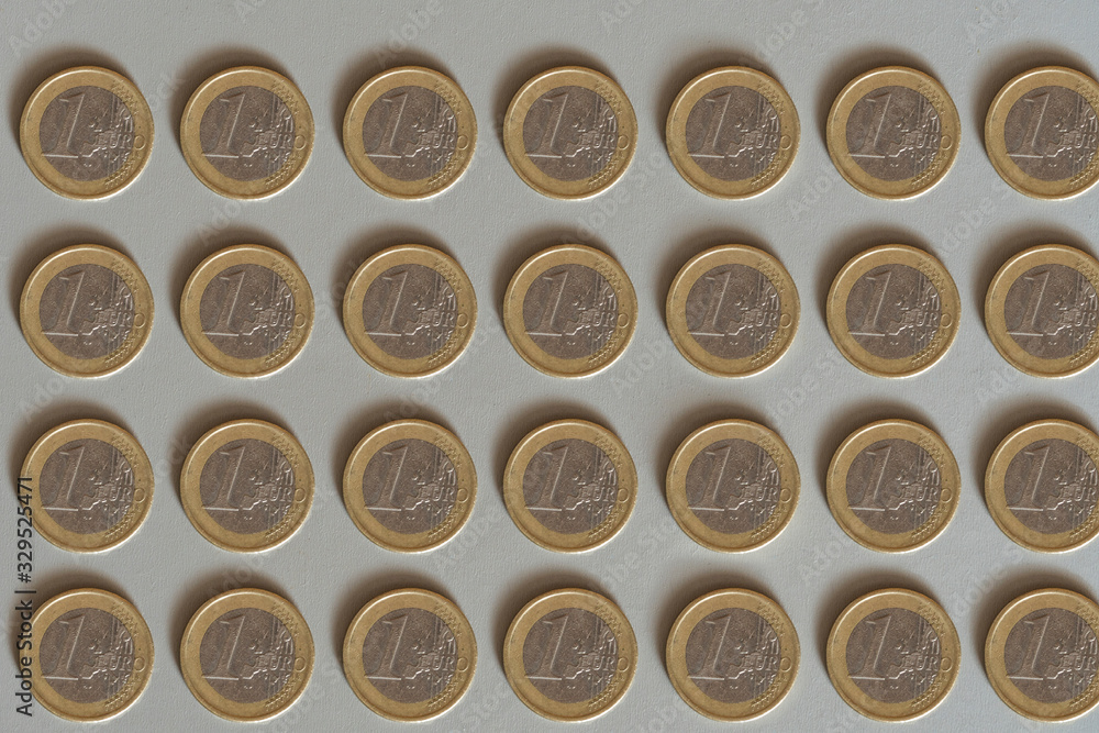 One euro coins layout on white background top down view. Finance and money concept. One euro coins layout on white background top down view. Finance and money concept.