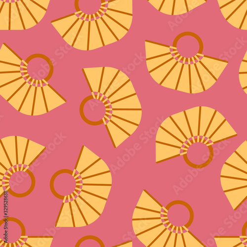 Seamless pattern with a yellow oval beach bag with a geometric pattern and handles with rings.Bright summer pattern for textiles on a pink background.For beachwear.Vector illustration.