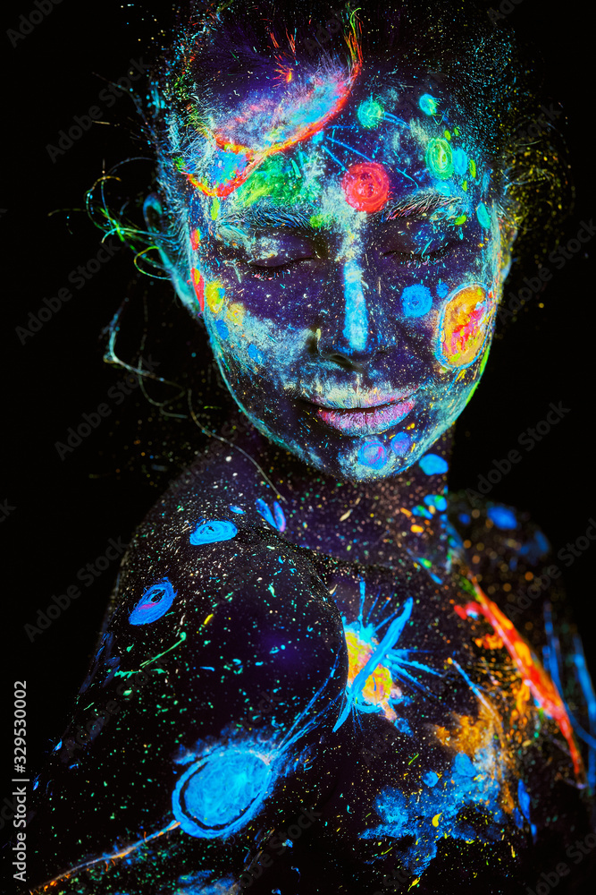 UV painting of a universe on a female body portrait Photos | Adobe Stock