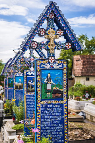 Characterstic painted graves on a famous Merry Cemetery in Sapanta village, Romania photo