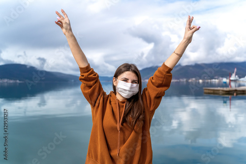 COVID-19 Young girl in city street wearing face mask protective for spreading of Coronavirus Disease 2019. . New travel cocept