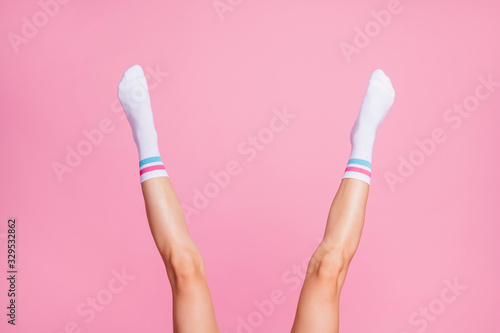 Cropped view of nice attractive lovely long vertical feminine legs wearing white casual soft socks new season brandy collection sale isolated over pink pastel color background