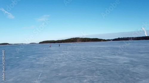 springtime lake Saimaa ice skaters in Rauha Lappeenranta Finland photo