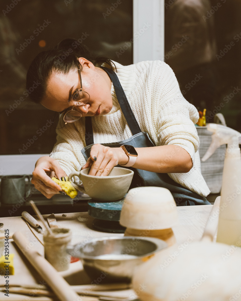 Woman making ceramic pottery on workshop. Concept for woman in freelance, business. Handcraft Woman making ceramic pottery on workshop. Concept for woman in freelance, business. Handcraft
