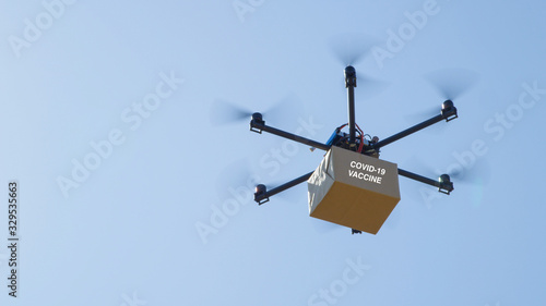 CLOSE UP Unmanned helicopter carries a brown package containing COVID-19 vaccine