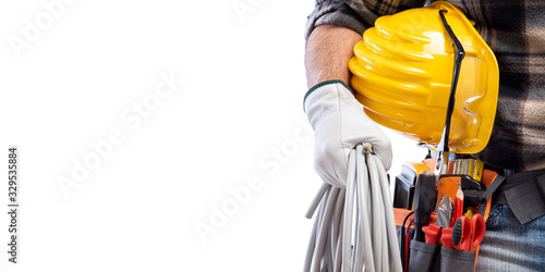 Electrician holds the roll of electric cable in his hand, helmet with protective goggles. Construction industry, electrical system. Isolated on a white background. photo