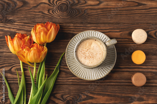 Wallpaper Mural orange tulips, cup with coffee and macaroon cookies on a wooden background, copy space Torontodigital.ca