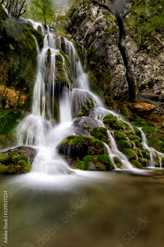 Long exposure of a beautiful waterfall with green moss, Beusnita, Cheile Nerei National Park, Romania