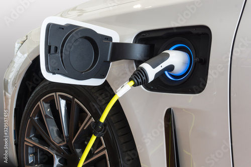 Power supply connect to electric car for add charge to the battery. Charging re technology industry transport which are the future