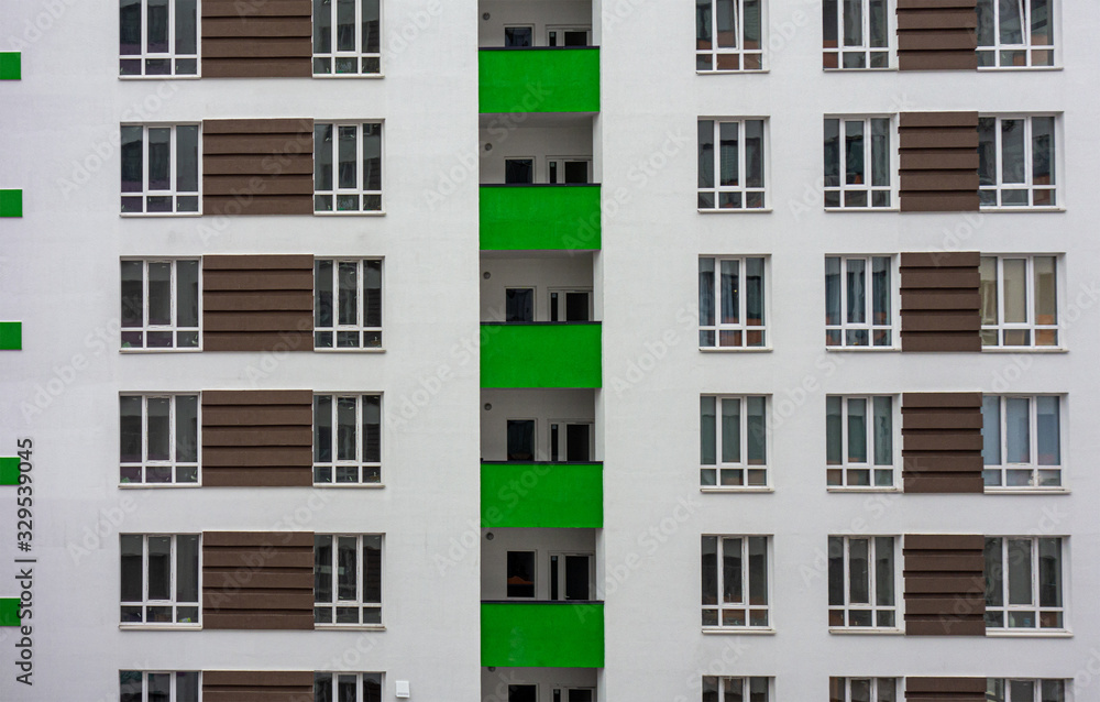 Building facade with windows and green balconies. Flat view pattern. Modern urban architecture background. Mortgage to buy private apartment concept