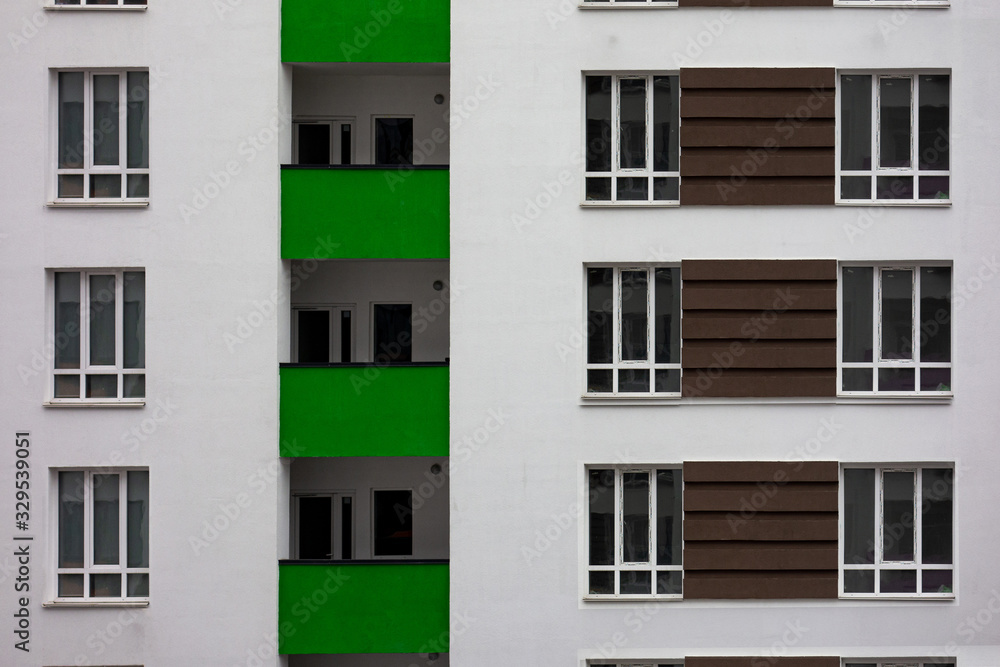Fototapeta premium Building facade with windows and green balconies. Flat view pattern. Modern urban architecture background. Mortgage to buy private apartment concept