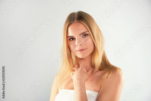 Beauty Woman face Portrait. Beautiful Spa model Girl with Perfect Fresh Clean Skin. Blonde female looking at camera and smiling. Youth and Skin Care Concept. Isolated on a white background